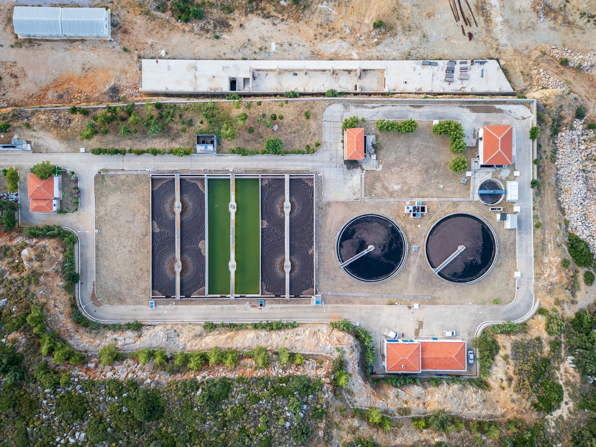 Aerial view of wastewater treatment plant with sedimentation tanks and filtration pools